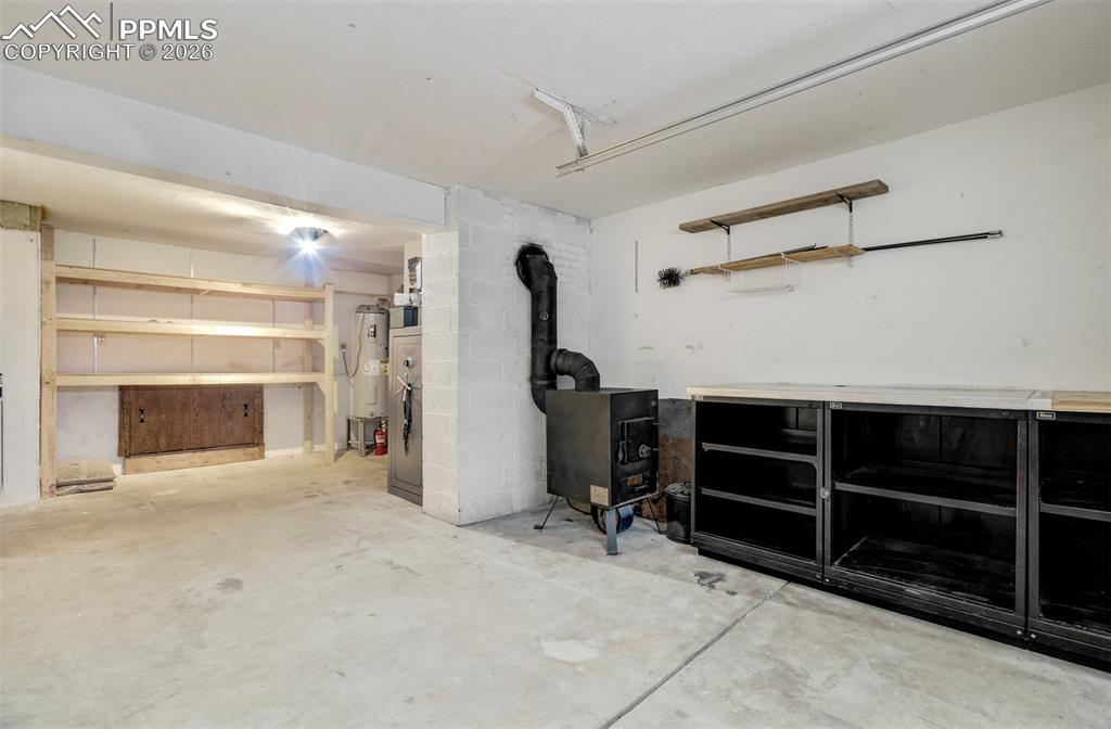 Image 33 of 45: Heated 3 car garage with wood burning stove in the left bay!