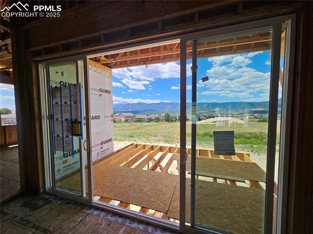 Image 12 of 25: Doorway to outside featuring a mountain view