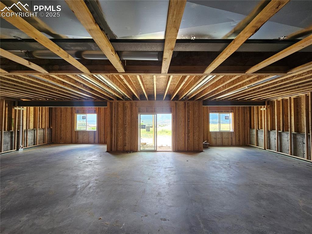 Image 18 of 25: Miscellaneous room featuring plenty of natural light and concrete flooring