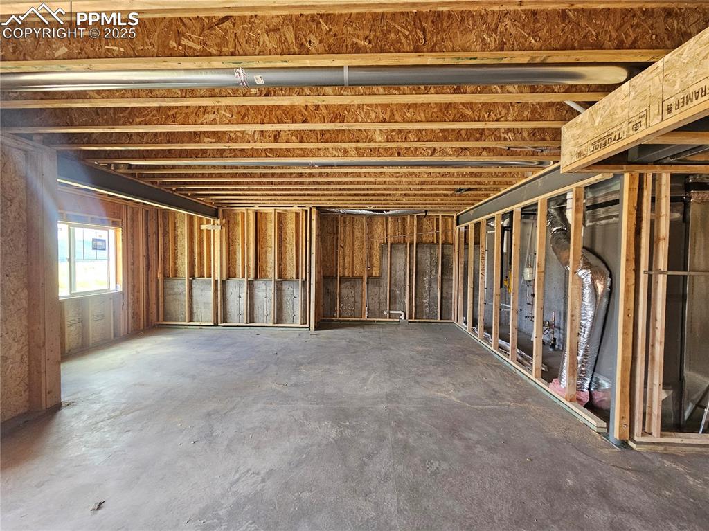 Image 20 of 25: Misc room with concrete flooring