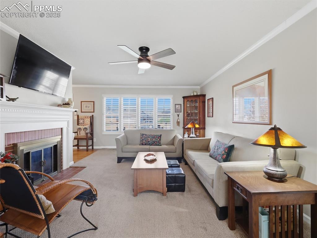 Image 11 of 47: Living room has a fireplace and large windows