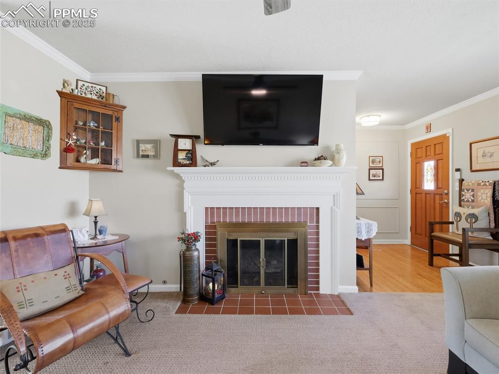 Image 12 of 47: Brick front fireplace in the living room