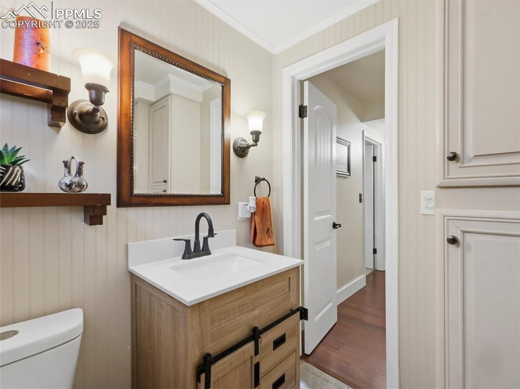 Image 31 of 47: Basement bathroom with a cabinet for linens