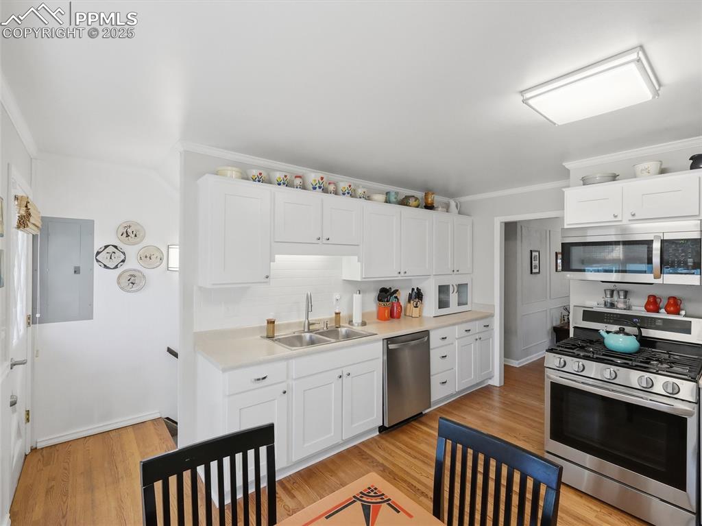 Image 6 of 47: The stairs to the basement are just off the kitchen 