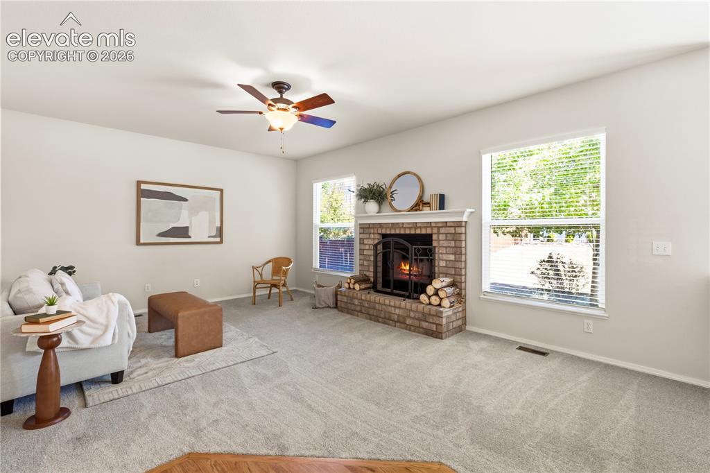 Image 16 of 50: Family room with wood burning fireplace