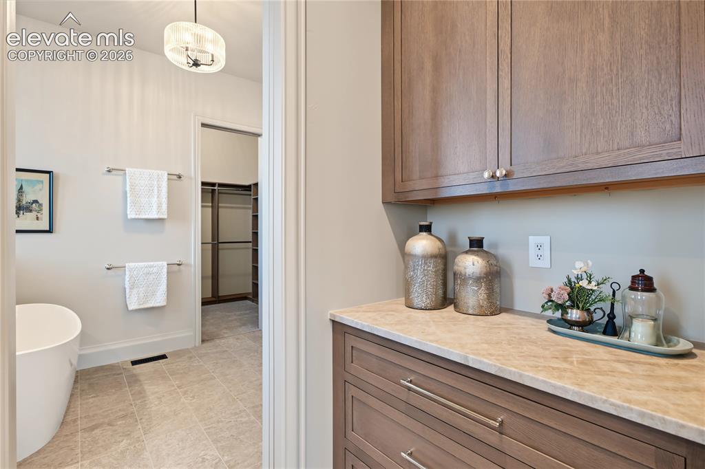 Image 12 of 50: Transition from primary bedrom and primary ensuite