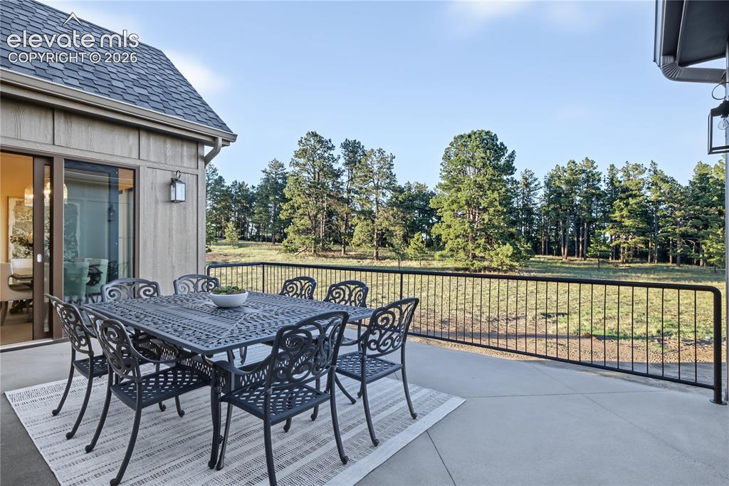 Image 20 of 50: Entertain your family and friends on this deck off the living room and dini