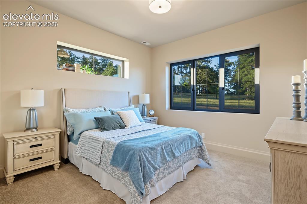 Image 35 of 50: Fourth bedroom with amazing views out into the trees, basement