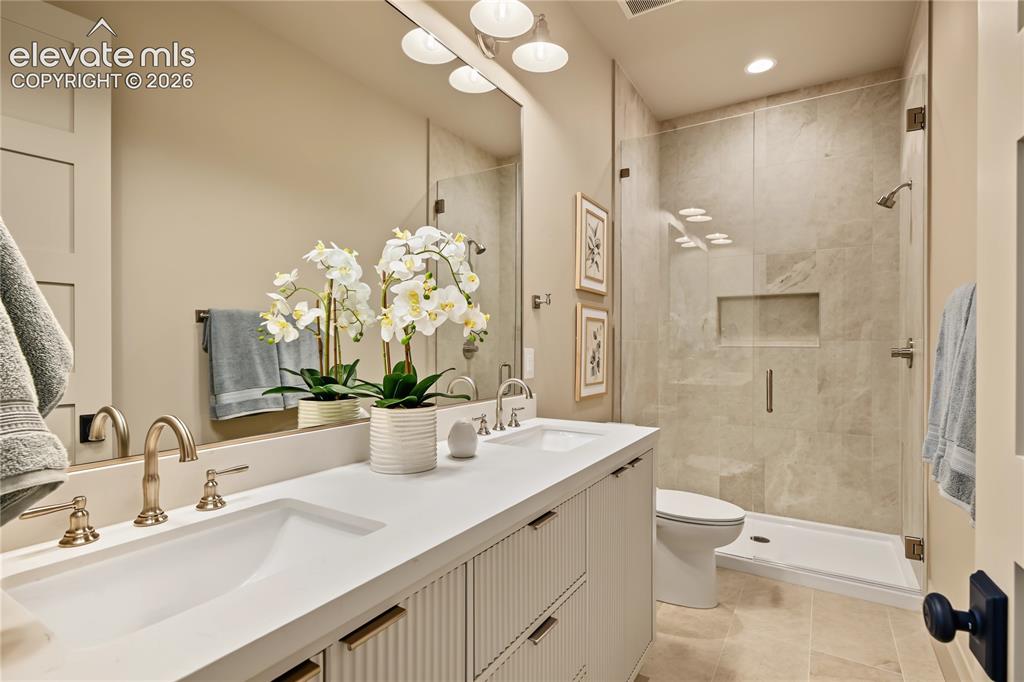 Image 37 of 50: Large double vanity with glass walk-in shower, basement