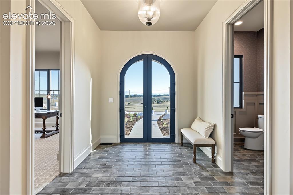 Image 6 of 50: Elegant entry with arched double doors