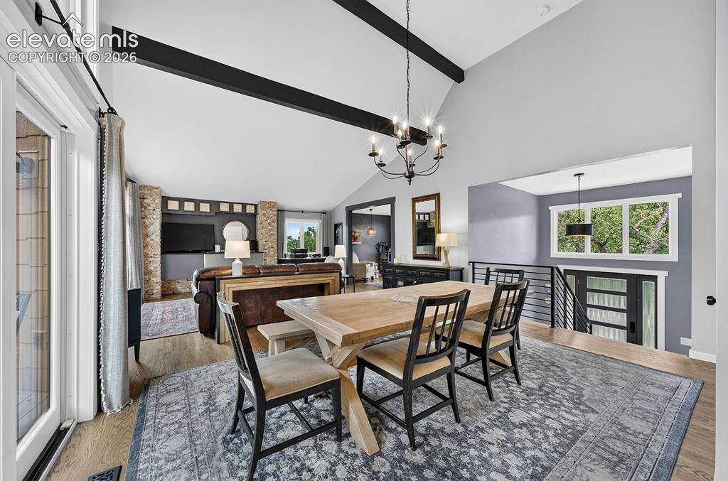Image 13 of 50: Dining room with walk-out access to the deck through a sliding glass door