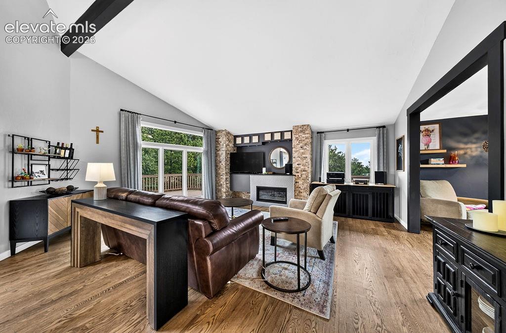 Image 19 of 50: Walk-out access to the deck, an office off the living room, and a gas inser