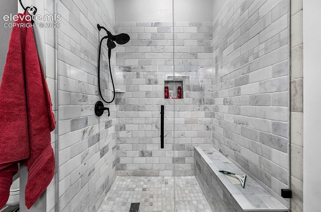 Image 28 of 50: Huge walk-in shower with fully tiled walls and floors in the beautiful prim
