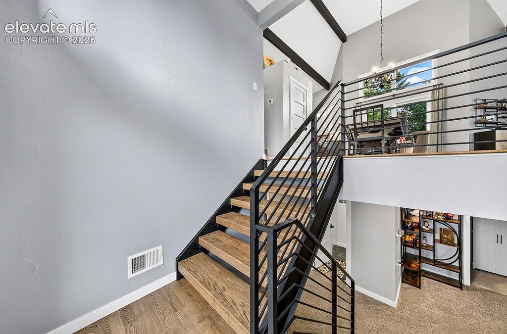 Image 5 of 50: Front entry opens to a split level staircase leading up to the upper level 