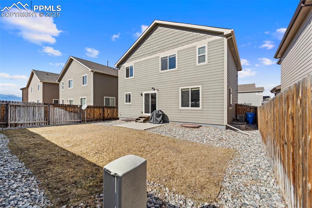Image 21 of 29: Back of property with a patio area, a fenced backyard, and central AC unit
