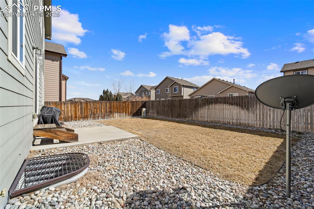 Image 22 of 29: View of yard with a patio area and a fenced backyard