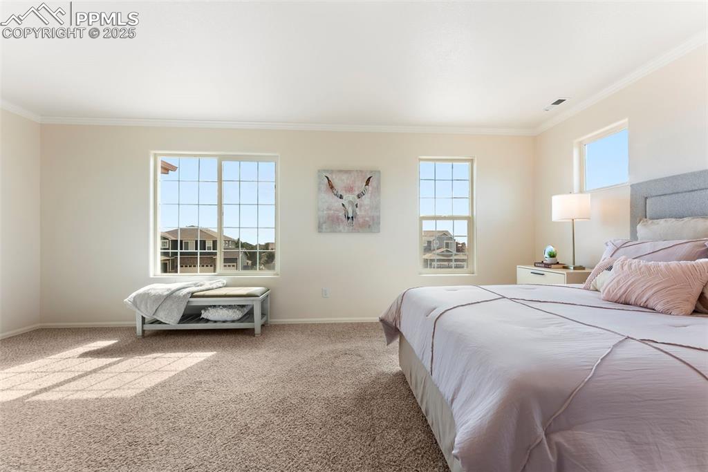 Image 17 of 50: Bedroom featuring crown molding and carpet