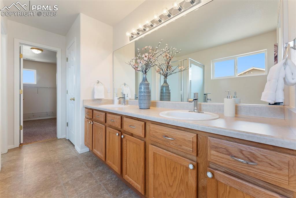 Image 19 of 50: Full bathroom featuring double vanity, plenty of natural light, a spacious 