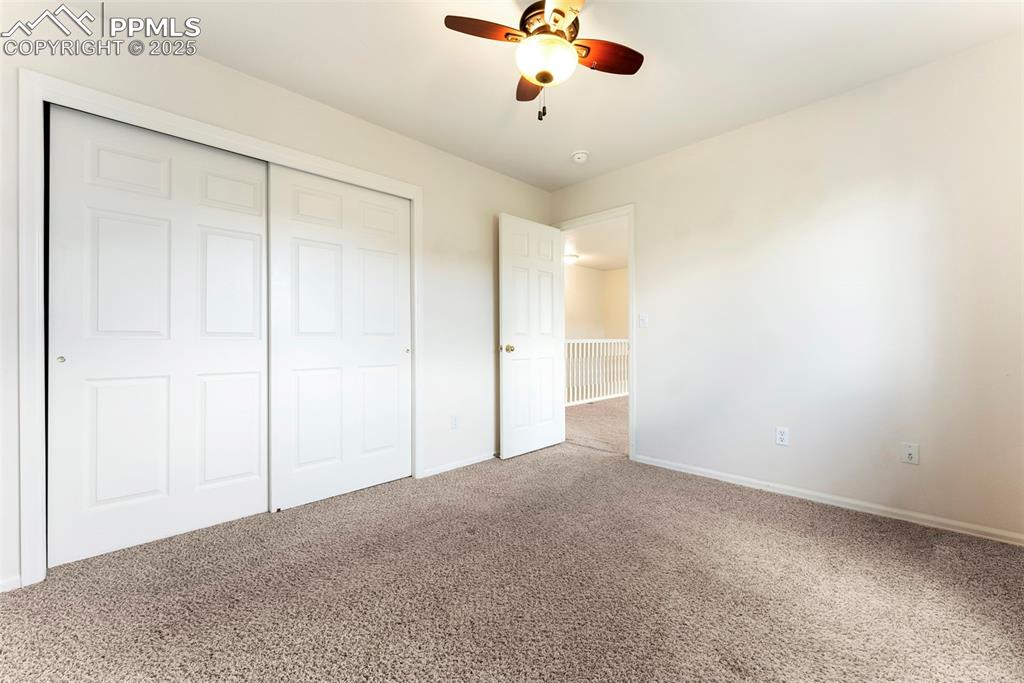 Image 22 of 50: Unfurnished bedroom featuring carpet flooring, a closet, and ceiling fan
