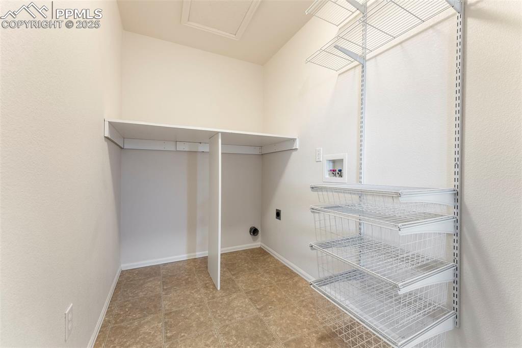Image 29 of 50: Laundry room with hookup for a washing machine and baseboards