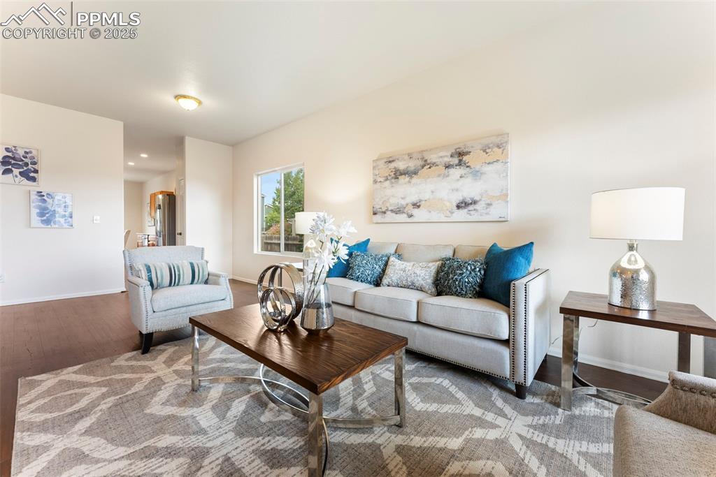 Image 3 of 50: Living area featuring wood finished floors and baseboards