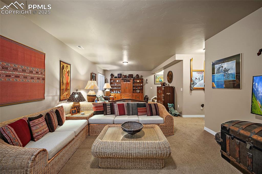 Image 27 of 39: Carpeted living room featuring baseboards