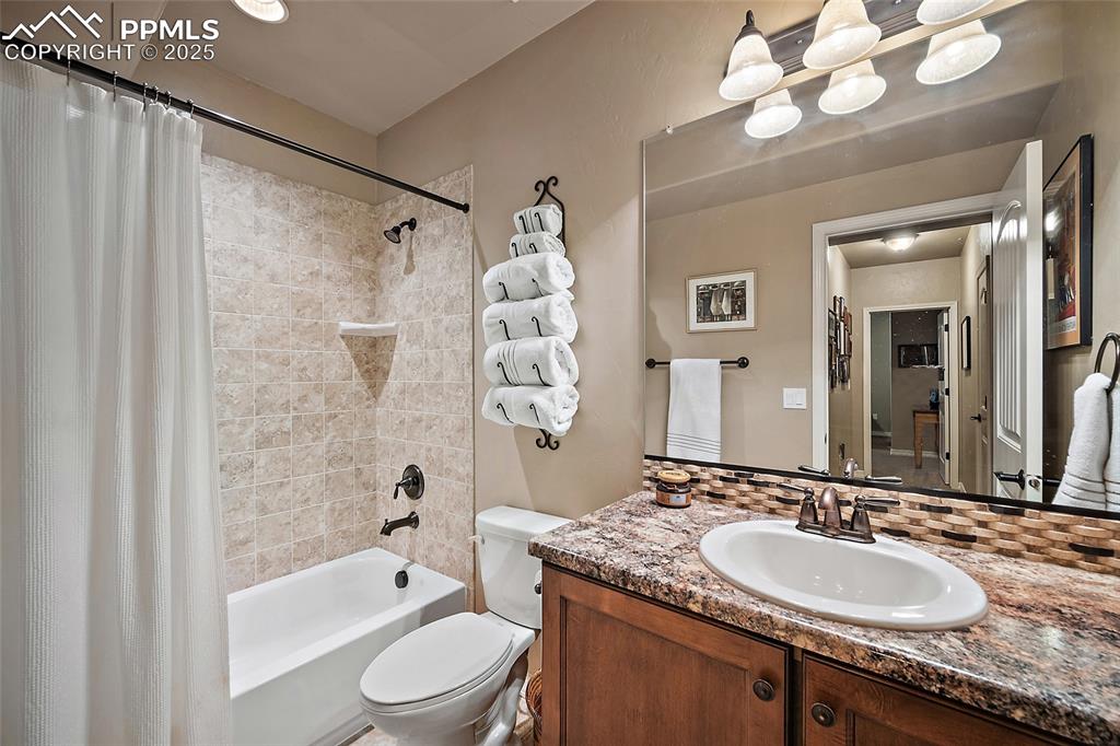 Image 31 of 39: Full bath featuring vanity and shower / tub combo with curtain