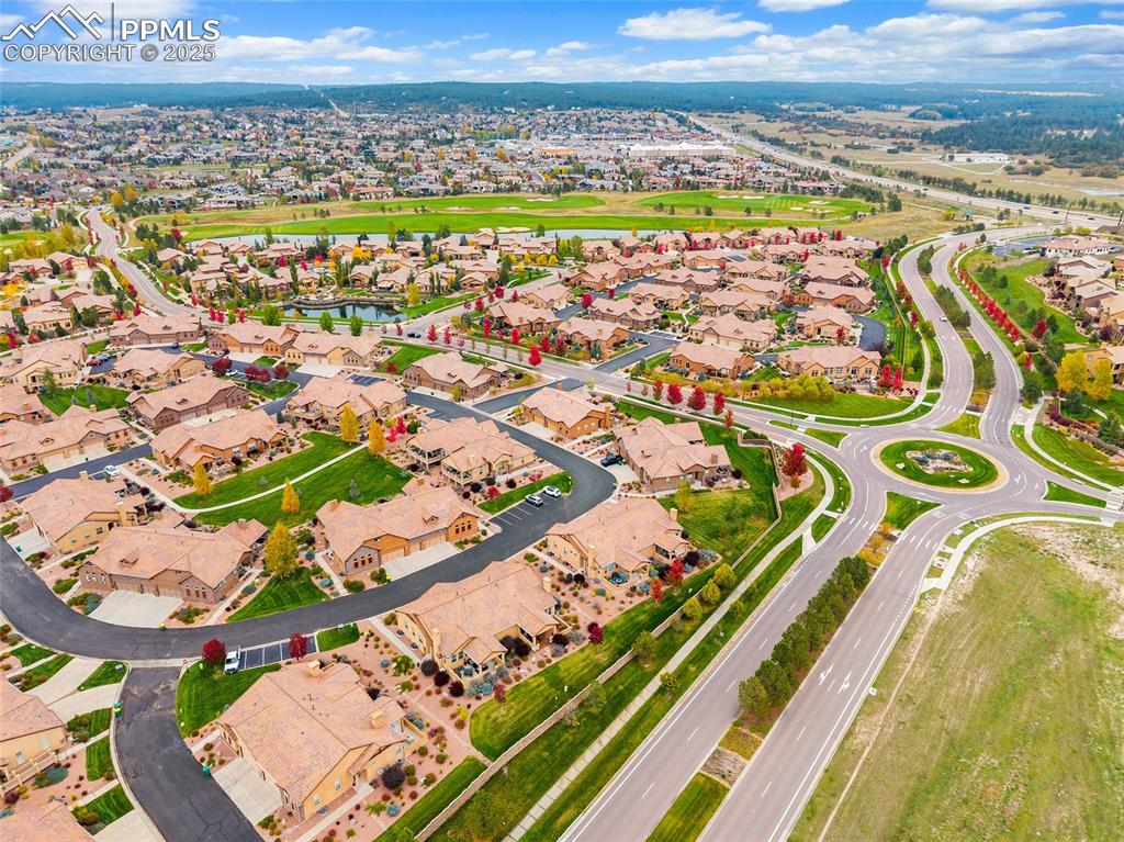Image 35 of 39: Aerial perspective of suburban area featuring a nearby body of water