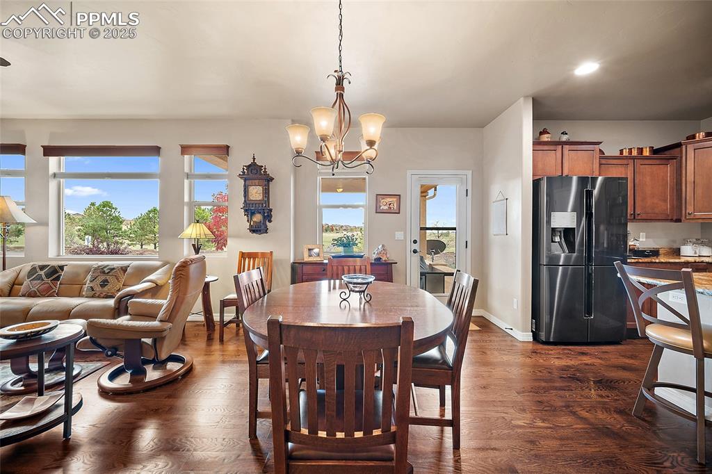 Image 8 of 39: Dining area featuring healthy amount of natural light, dark wood-type floor