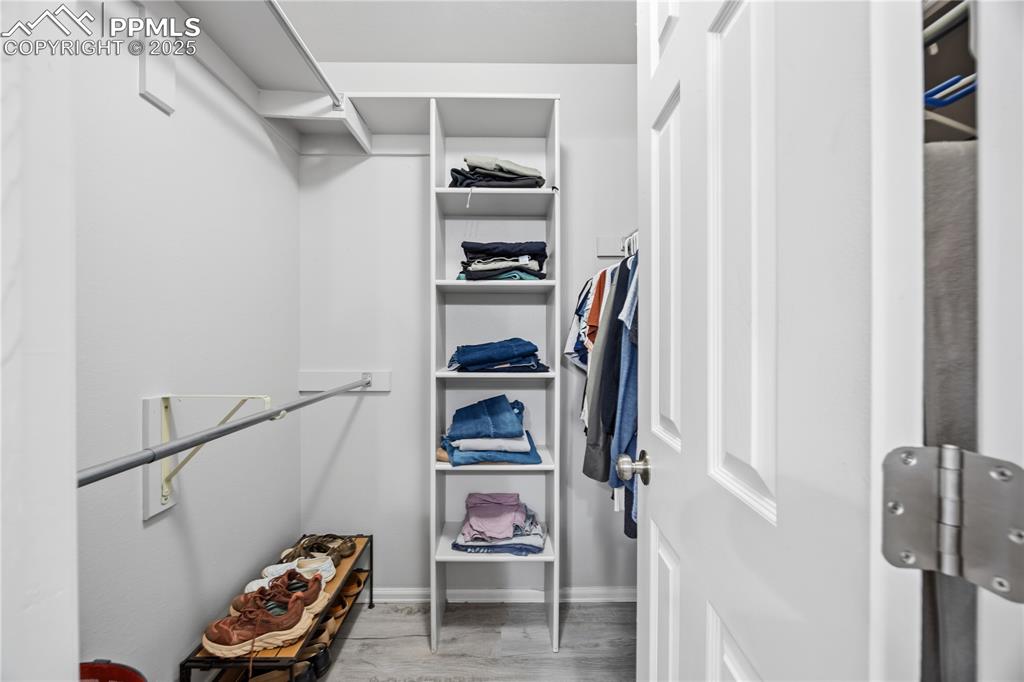 Image 27 of 50: Spacious closet with light wood-style flooring