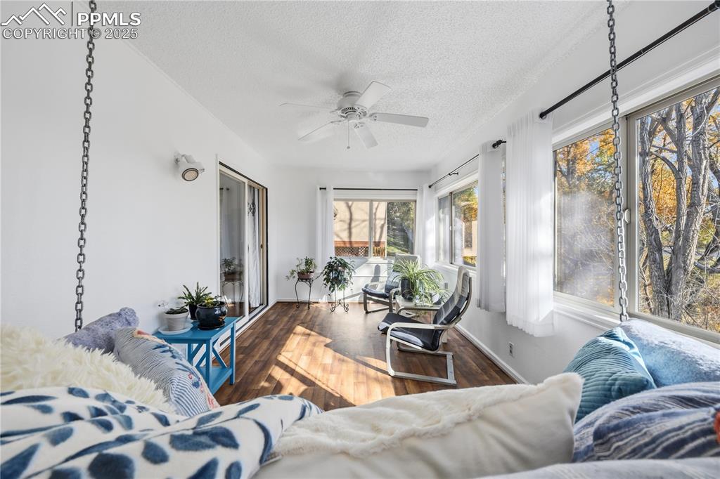 Image 29 of 50: Sunroom / solarium with wood finished floors and a textured ceiling