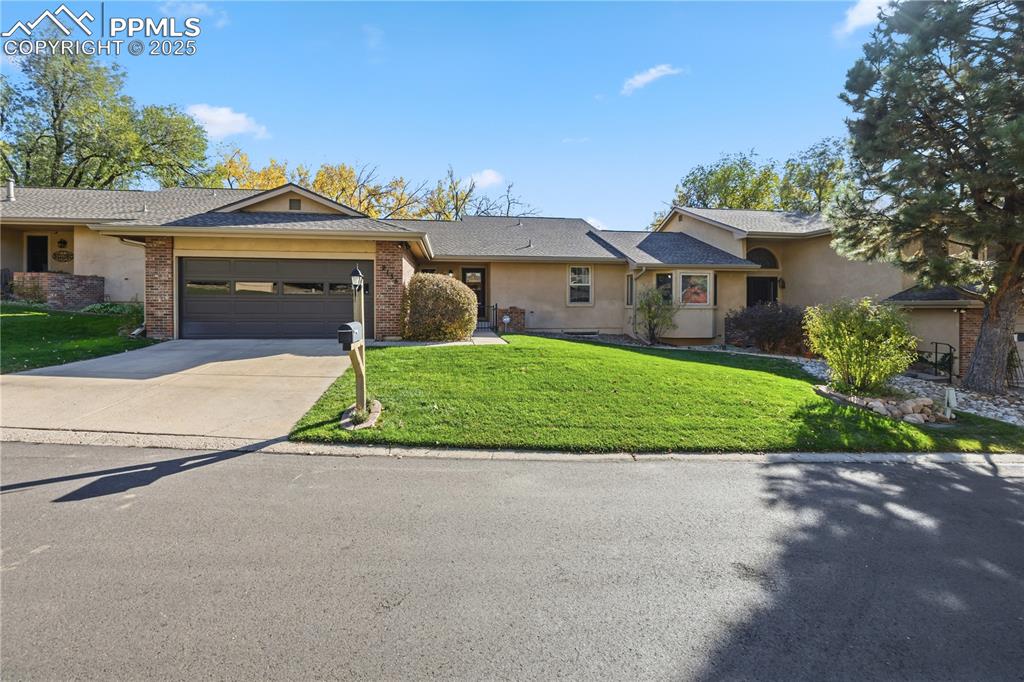 Image 3 of 50: Single story home featuring concrete driveway, a front yard, a garage, and 