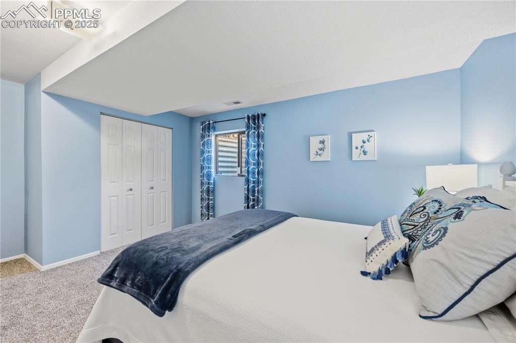 Image 33 of 50: Carpeted bedroom with a closet and baseboards