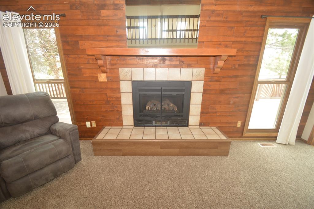 Image 11 of 45: fireplace on far wall of living room.