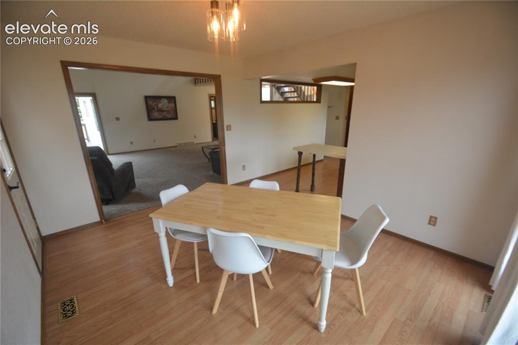 Image 17 of 45: view from dining room to living room and kitchen