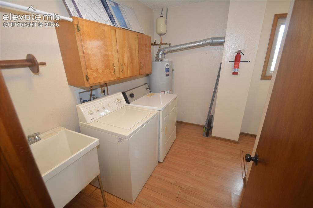 Image 23 of 45: Huge main level laundry space with Sink and window