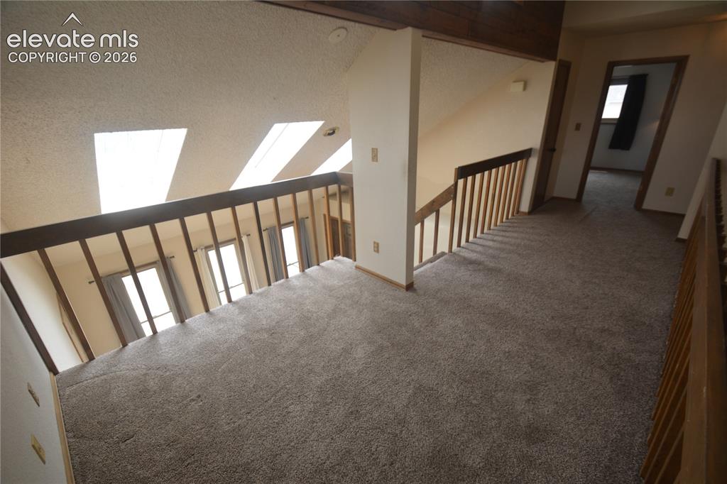 Image 30 of 45: loft looking toward front door. bedroom #2 door on the right.
