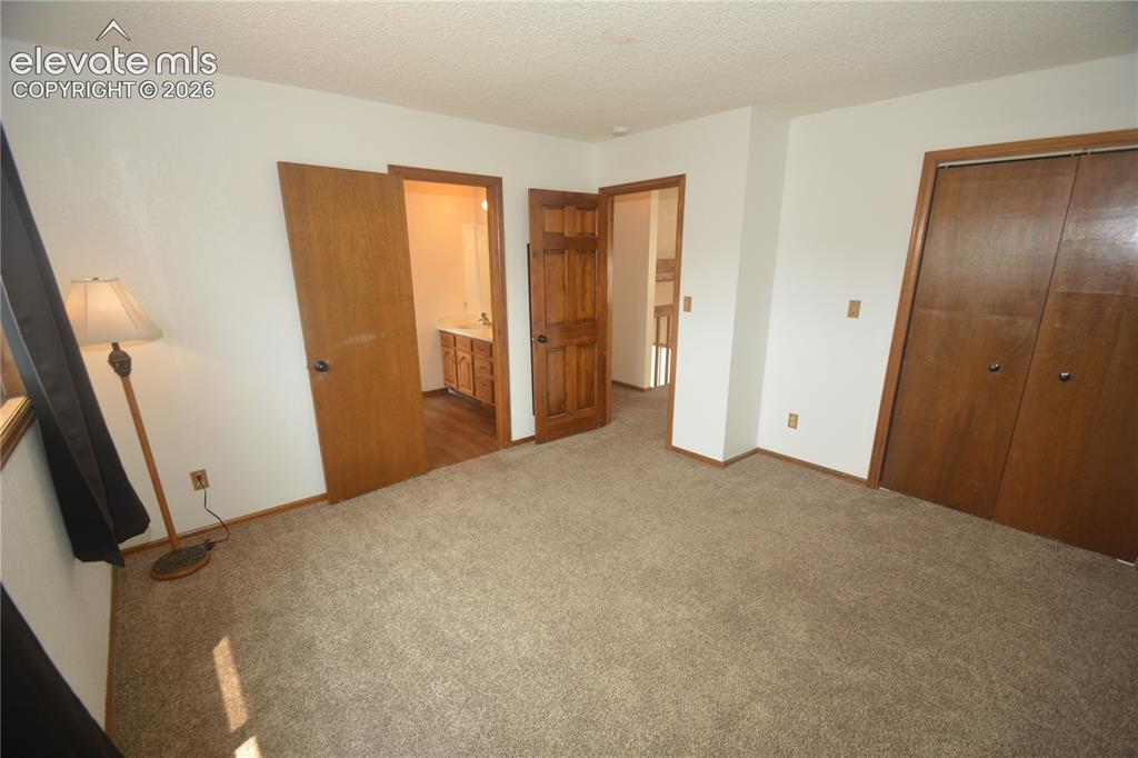 Image 32 of 45: bedroom #2 from inside looking toward entry and J&J attached bath.