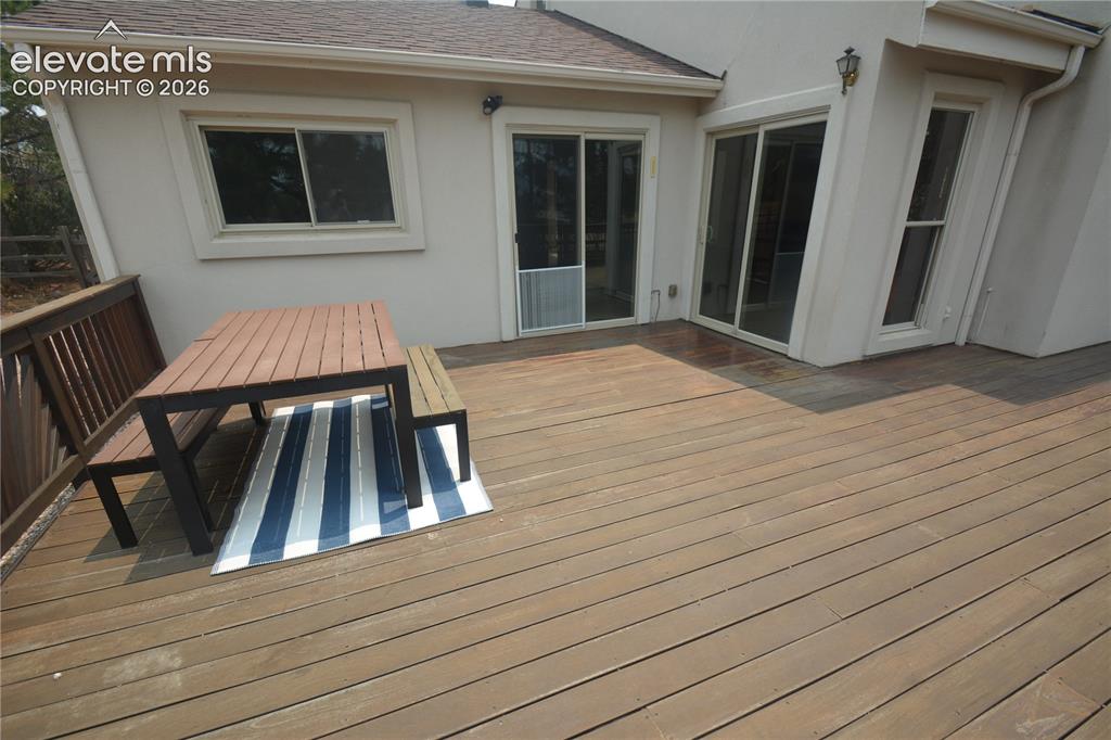 Image 38 of 45: Looking from deck toward living room and primary bedroom walk-outs. 16x17 p