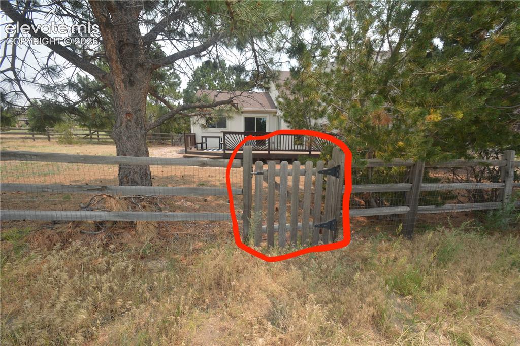Image 42 of 45: gate leading out to walking trails