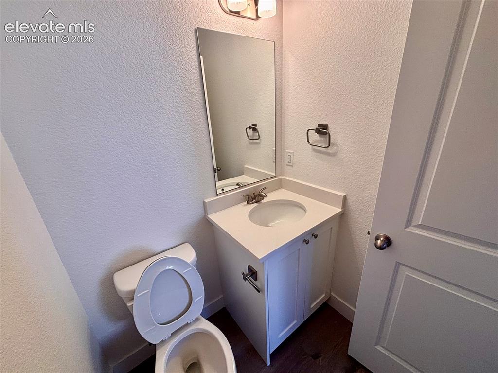 Image 6 of 17: White vanity with an integrated sink and brushed nickel hardware