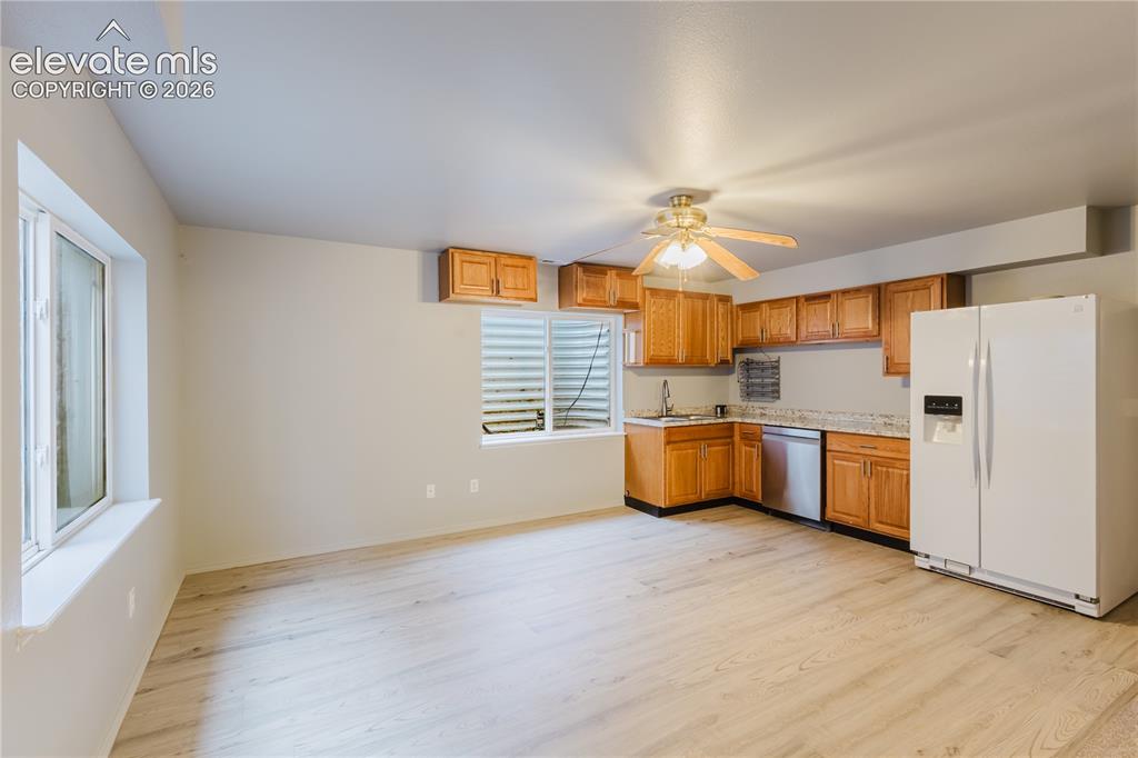 Image 30 of 39: Basement kitchenette and dining space
