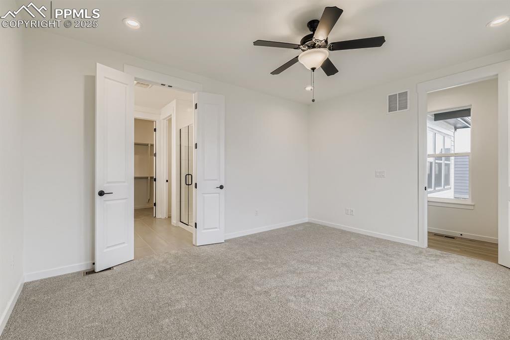 Image 12 of 28: Unfurnished bedroom with light carpet, recessed lighting, and ceiling fan