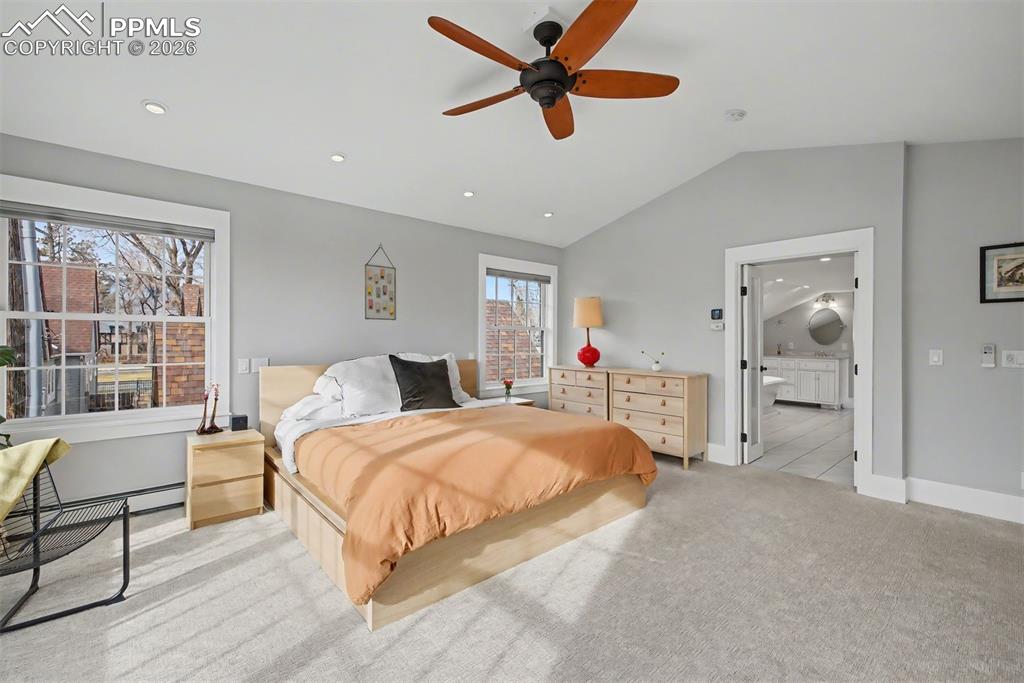 Image 23 of 43: Primary suite with French doors to the en suite bathroom.