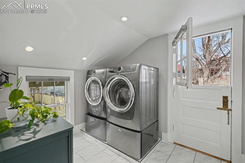 Image 27 of 43: The laundry room features a fun Dutch door to the front balcony for fresh a