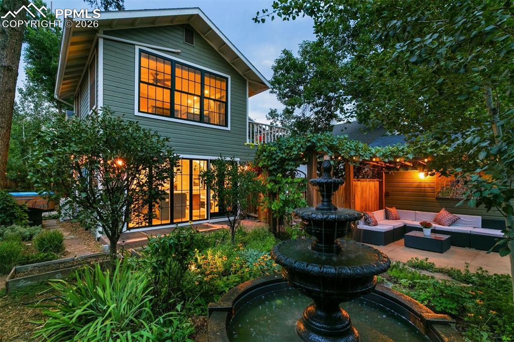 Image 37 of 43: Enjoy summer nights on the back patio with the soothing water fountain and