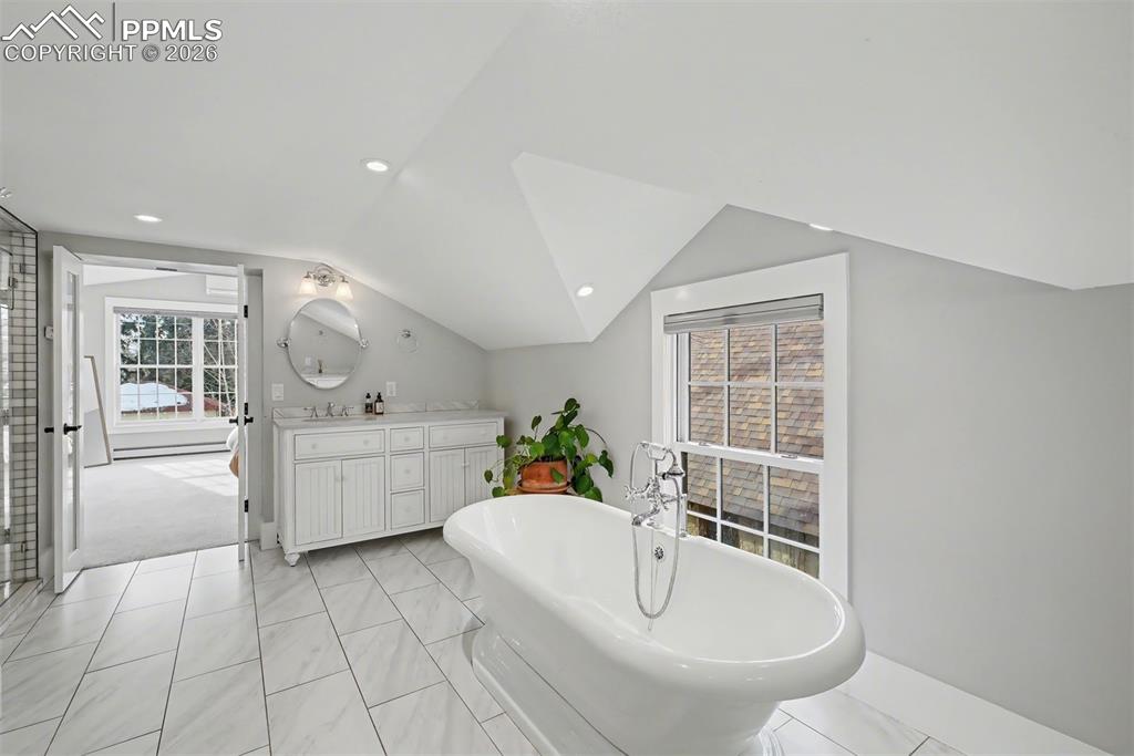 Image 7 of 43: Spa like primary en suite bathroom with heated floors, soaking tub, double