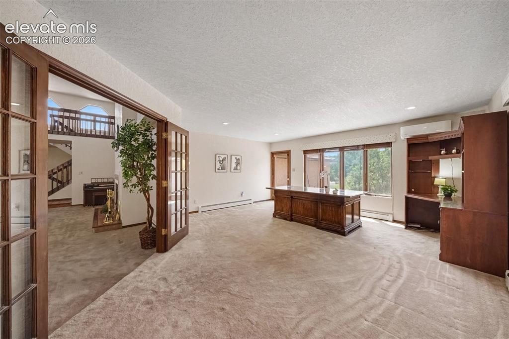 Image 12 of 44: Main-level office features French doors, creating a quiet and versatile wor