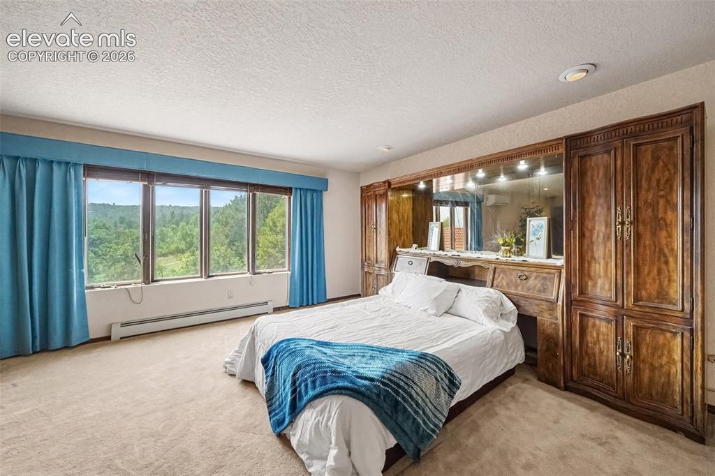 Image 18 of 44: Primary bedroom provides convenient access to the adjoining bathroom, creat