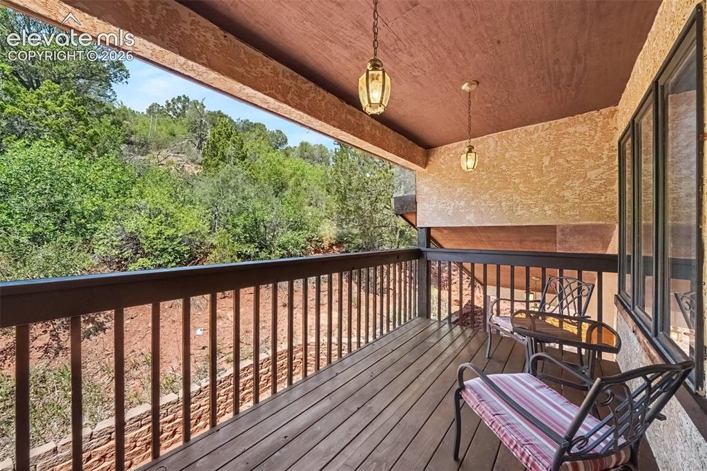 Image 19 of 44: Stained covered deck accessible directly from the second primary bedroom